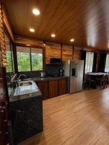 a kitchen with a sink and a refrigerator at Cabaña Lancero in San Pedro