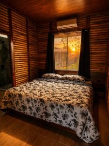 a bed in a room with a window in a room at Cabaña Lancero in San Pedro