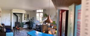 a living room with a table and a vase at Bed en Bad Heerlijk in Kotten