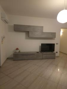 a living room with a flat screen tv on a wall at Casa Cirillo in Marigliano