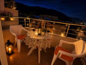a table and chairs on a balcony at night at SeaSideApartman3 in Budva +1 photo
