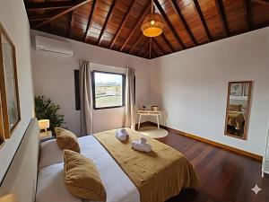 a bedroom with a large bed with a wooden ceiling at Casona IROKO in La Costa