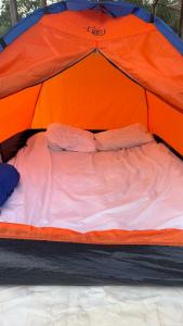 a bed in an orange and blue tent at StNicholas Ranch Corfu Wild Camping 2 in Benitses