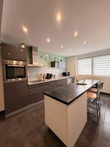 a large kitchen with a large island in the middle at Duplex-Cocon-Proximité - frontières in Hombourg-Haut