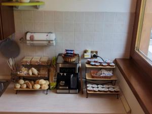 a toy kitchen with bread and food on shelves at Winter and Summer Cortina in Cortina dʼAmpezzo