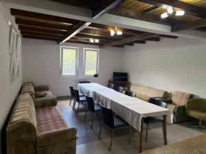 a dining room with a long table and chairs at DreamHouse Grebaje in Gusinje