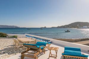a patio with chairs and a table and the ocean at Pera Milos villa in Pollonia