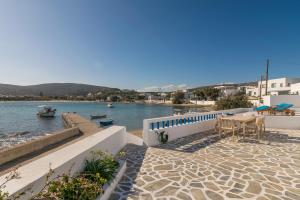 a patio with a table and a view of the water at Pera Milos villa in Pollonia
