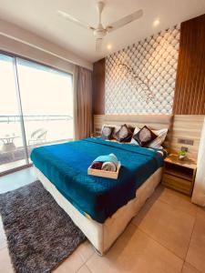 a bedroom with a large bed with a blue blanket at Luxury sup nova in New Delhi
