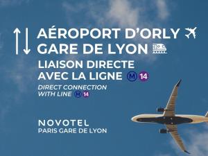 an airplane is flying in the sky at Novotel Paris Gare De Lyon in Paris