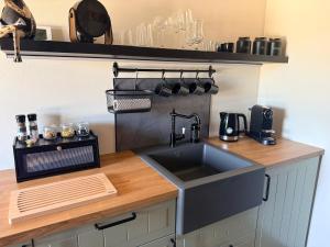 a kitchen with a sink and a counter at B&B Goeje Morge in Ammerzoden