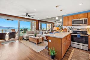 a kitchen and living room with a view of the ocean at Lahaina Roads 306 in Lahaina