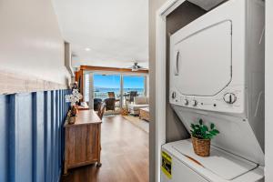 a kitchen and living room with a view of the ocean at Lahaina Roads 306 in Lahaina