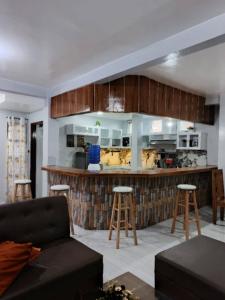 a living room with a couch and a kitchen at Nenita in Baybay