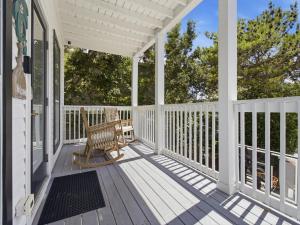a white porch with a bench on it at Dune Our Thing in Blue Mountain Beach +41 photos