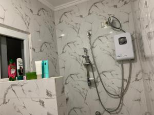 a shower in a bathroom with a marble wall at Nenita in Baybay +93 photos