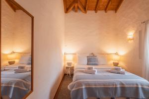 a bedroom with two beds and a large mirror at Cerca do Sul in Brejao +17 photos