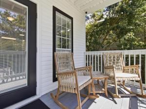 two chairs and a table on a porch at Dune Our Thing in Blue Mountain Beach