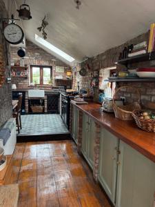 a kitchen with wooden floors and a counter top at THE FARMHOUSE Room 2 in Balcunnin