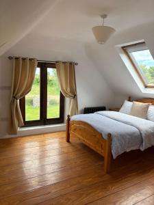 a bedroom with a bed and a large window at THE FARMHOUSE Room 2 in Balcunnin
