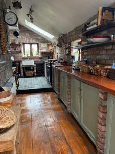 a kitchen with a long counter and a counter top at THE FARMHOUSE Room 2 in Balcunnin +32 photos