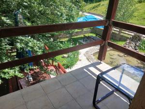 a balcony with a chair and a view of a garden at Savnik moutain appartement in Šavnik