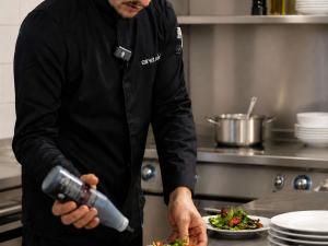 a man in a kitchen preparing a plate of food at Ibis Styles Evry Lisses Paris Sud in Courcouronnes +60 photos