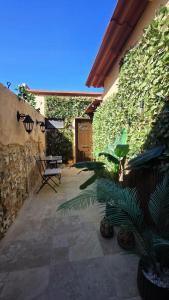 a patio with a table and plants and a building at Domus Fidias in Rhodes Town
