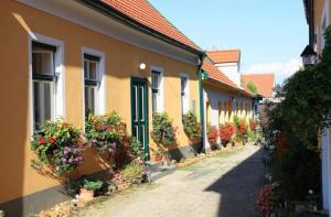 a row of houses with flower pots on a street at Ferienhaus Schmidlhof in Oggau