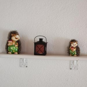 a shelf with two figurines and a lantern on it at Ferienhaus Schmidlhof in Oggau