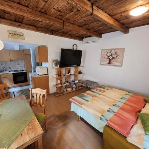 a living room with a large bed and a kitchen at Ferienhaus Schmidlhof in Oggau