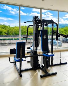 a gym with two blue chairs and a treadmill at Apto Isabelu Girardot in Girardot