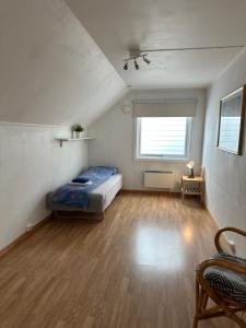 a large room with a bed and a window at Loft apartment with 3 bedrooms in Trondheim