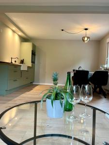 a table with wine glasses and a potted plant on it at Ferienhaus Kropsbach in Sankt Martin