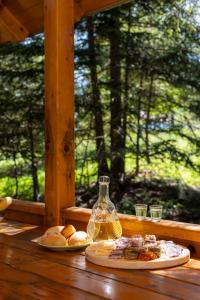 a table with two plates of food on a porch at Zlatar Zen Chalet in Vukovina