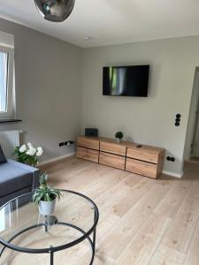 a living room with a couch and a tv on a wall at Ferienhaus Kropsbach in Sankt Martin