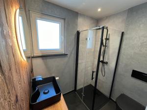a bathroom with a shower and a sink at Ferienhaus Kropsbach in Sankt Martin +16 photos