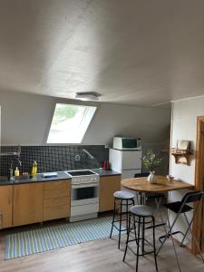 a kitchen with a table and chairs and a window at Loft apartment with 3 bedrooms in Trondheim
