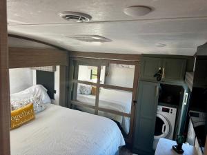 a small bedroom with a bed and a window at EL Camper KW in Key West