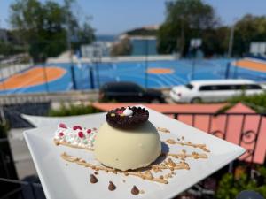 a dessert on a white plate on a table at ApartHotel Viola in Pula
