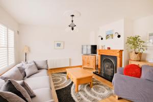 a living room with a couch and a fireplace at Beautiful 3 Bedroom House in Ennistymon