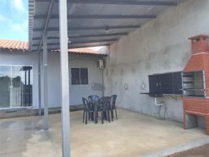 a patio with a group of chairs and a fireplace at Alter do Chão Casa 02 in Alter do Chao