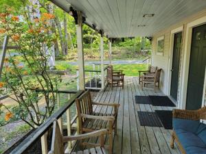 a porch with rocking chairs on a house at Hawks House Inn in Walpole