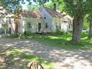 a white house with a tree in the yard at Hawks House Inn in Walpole