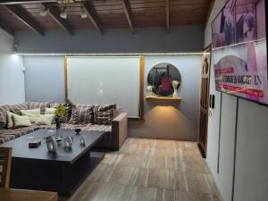a living room with a couch and a table at BAHIA BLANCA-BARRIO PARQUE in Bahía Blanca