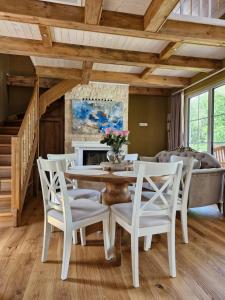 a dining room with a table and chairs and a couch at Seventh Heaven Village Glamping in Rogašovci