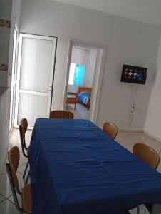 a dining room with a blue table and chairs at B Résidence in Salakta +12 photos