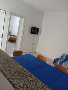 a room with a bed with a blue sheet on it at B Résidence in Salakta