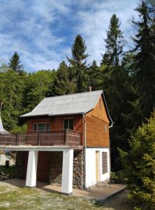 a house with a deck on top of it at Srub v lese in Hrabŭvka