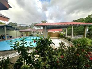 a house with a swimming pool and a gazebo at Casa Playa Cieneguita in Puerto Cortés